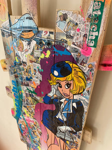 Vibrant pop art of Natacha on recycled wood, featuring colorful elements and dynamic design inspired by comic series.